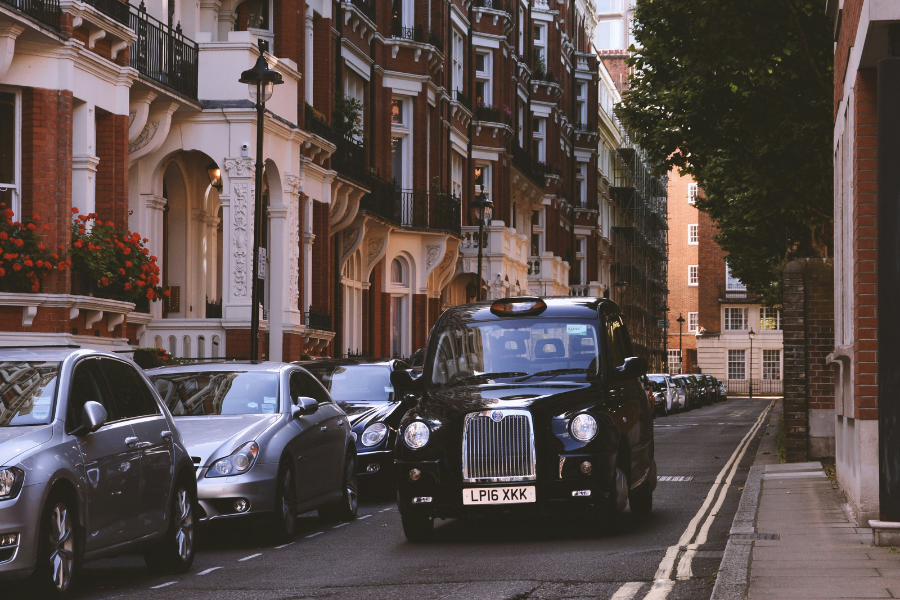 London taxi driving along a road